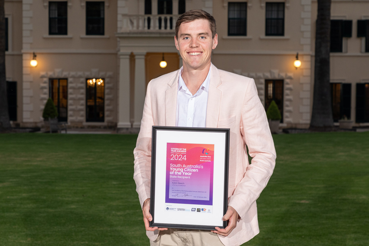 Image of Kylan Beech holding young Citizen of the Year certificate