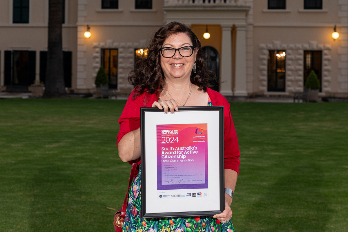 Image of Jody Moate holding commendation for Active Citizen certificate