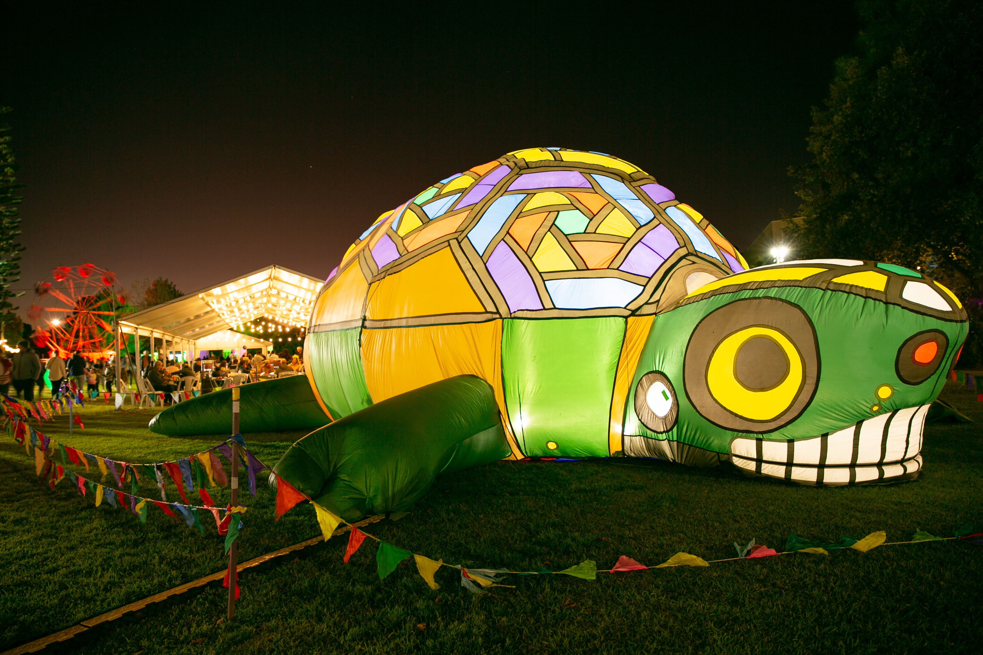 An inflated lit up turtle at night markets