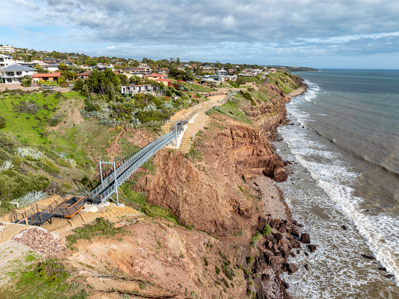 An aerial image of the suspension bridge across the clifftops