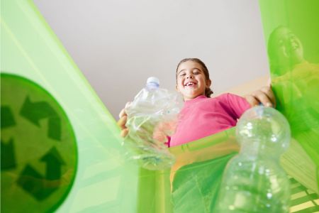 Girl recycling plastic 