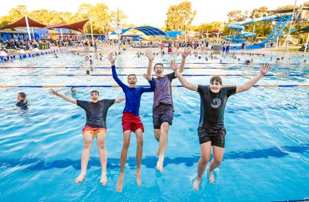 4 youths jumping into the Ridgehaven Lap swimming pool